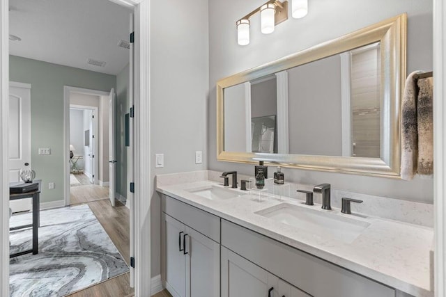 bathroom featuring vanity and hardwood / wood-style floors