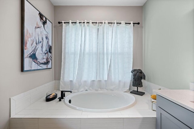 bathroom featuring vanity and a relaxing tiled tub