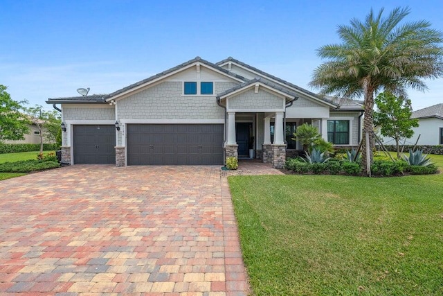 craftsman inspired home featuring a garage and a front lawn