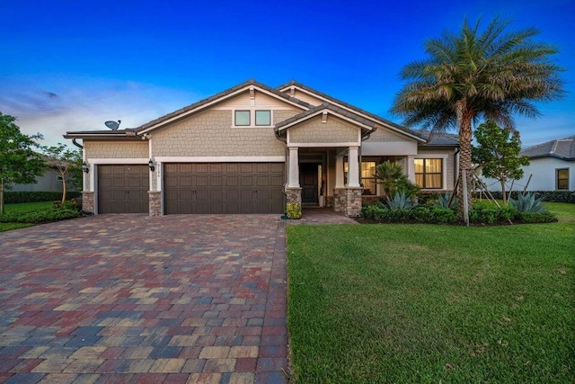 craftsman house with a garage and a lawn