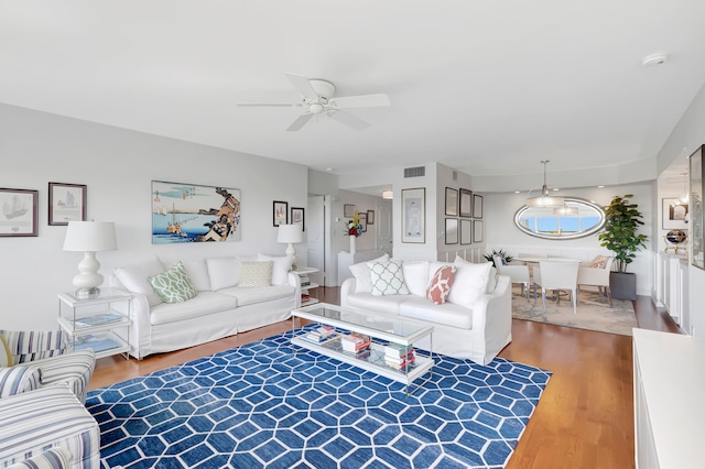 living room with hardwood / wood-style floors and ceiling fan