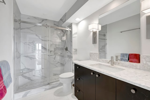 bathroom featuring an enclosed shower, vanity, and toilet