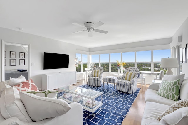 living room with ceiling fan and hardwood / wood-style floors