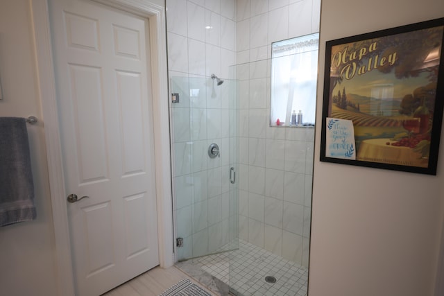 bathroom with a shower with door