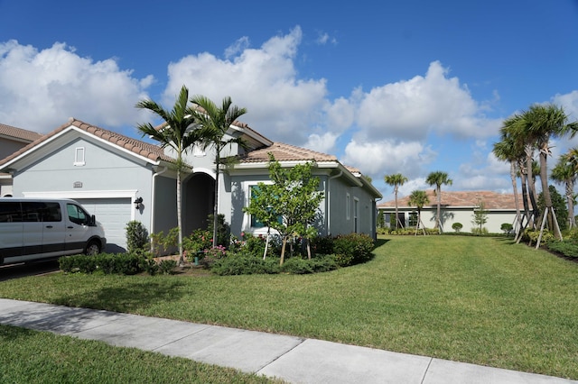 view of front facade featuring a garage and a front lawn