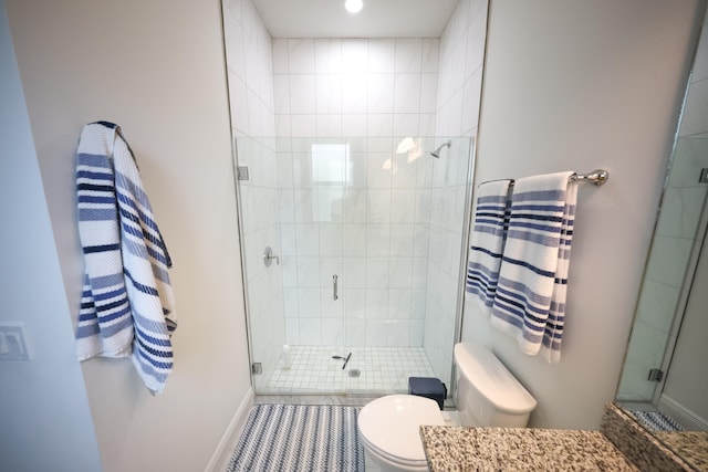 bathroom featuring tile patterned floors, vanity, toilet, and a shower with shower door