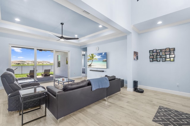 living room with ceiling fan, light wood-type flooring, and crown molding