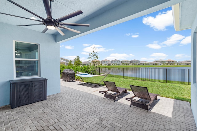 view of patio / terrace with a water view and ceiling fan