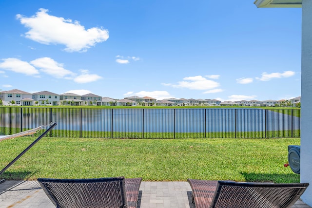 view of yard with a water view and a patio area