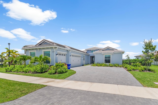 view of front of home featuring a garage and a front yard