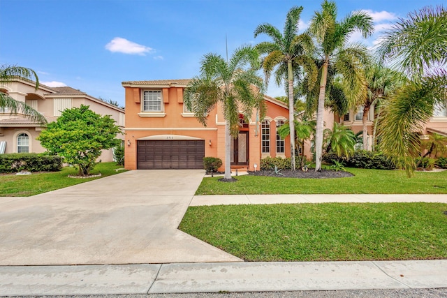 mediterranean / spanish-style house with a front yard and a garage