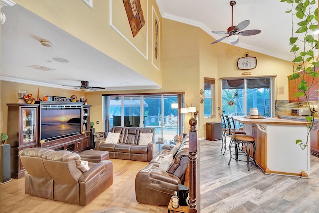 living room with light wood-type flooring, ceiling fan, and ornamental molding