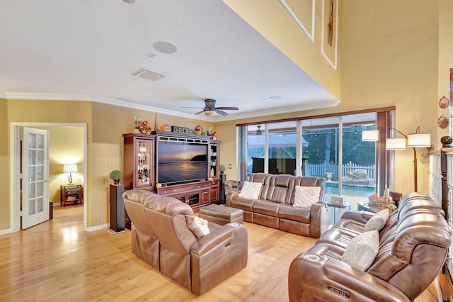 living room featuring ceiling fan, light hardwood / wood-style floors, and ornamental molding