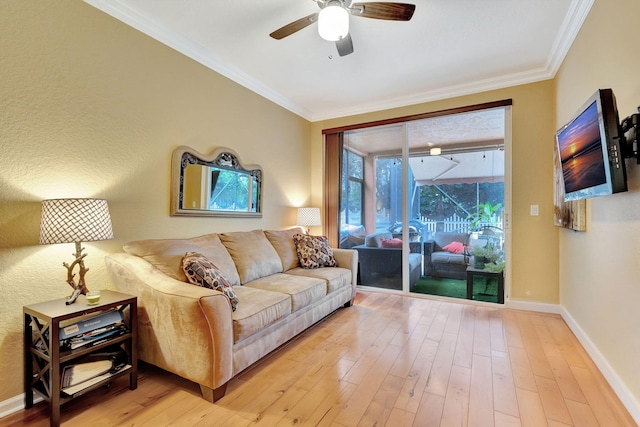 living room featuring light wood-type flooring, ceiling fan, and crown molding