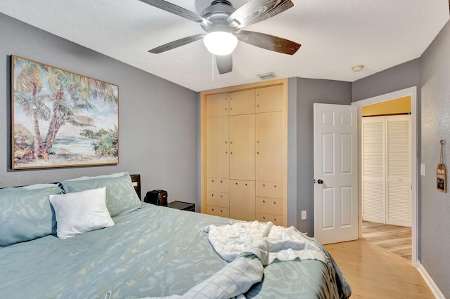 bedroom featuring ceiling fan and light hardwood / wood-style flooring