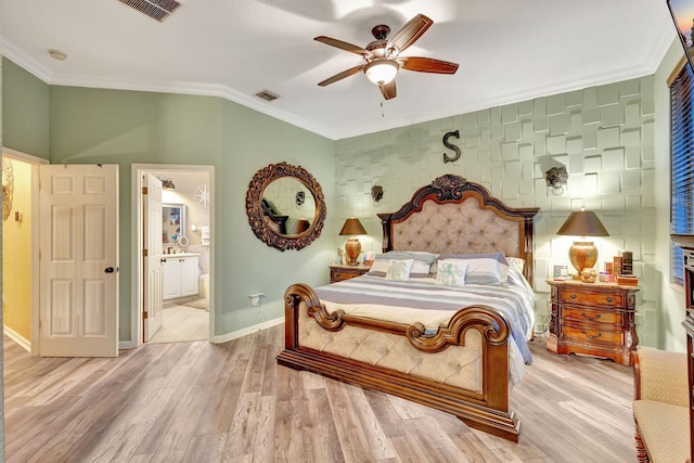 bedroom with ceiling fan, light wood-type flooring, crown molding, and connected bathroom