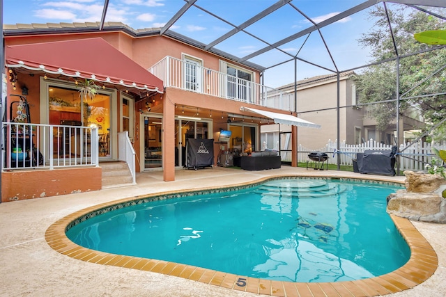 view of pool with a patio area and a lanai