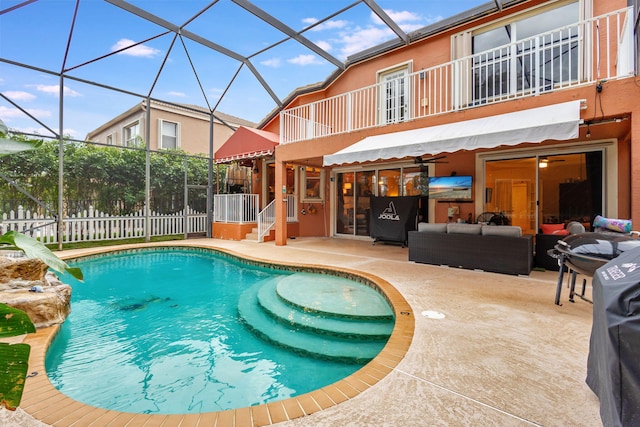 view of swimming pool with an outdoor living space, glass enclosure, and a patio area