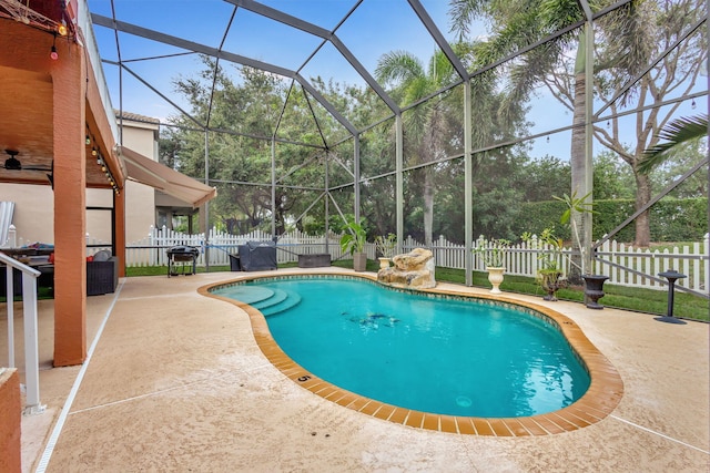 view of swimming pool with a lanai and a patio area