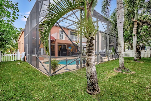 view of pool with a lanai and a yard