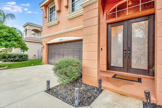 entrance to property featuring french doors and a garage