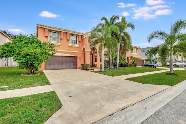 mediterranean / spanish-style home featuring a front lawn and a garage