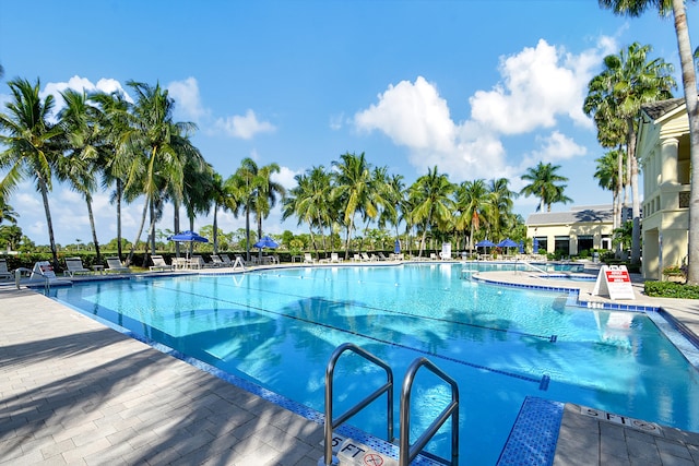 view of swimming pool with a patio area and a hot tub