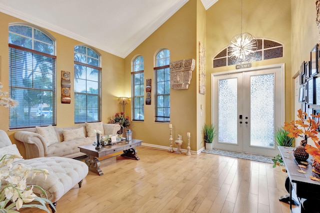 entrance foyer featuring french doors, light hardwood / wood-style floors, and a healthy amount of sunlight