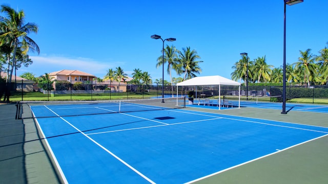 view of tennis court featuring basketball hoop