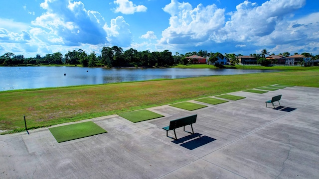 view of community with a yard and a water view