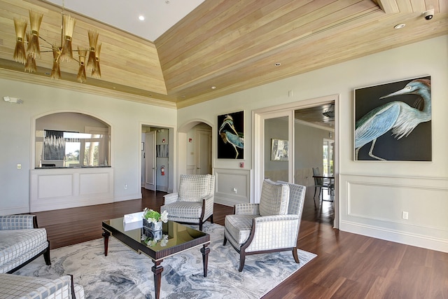 living room featuring wooden ceiling, a towering ceiling, a healthy amount of sunlight, and dark hardwood / wood-style floors