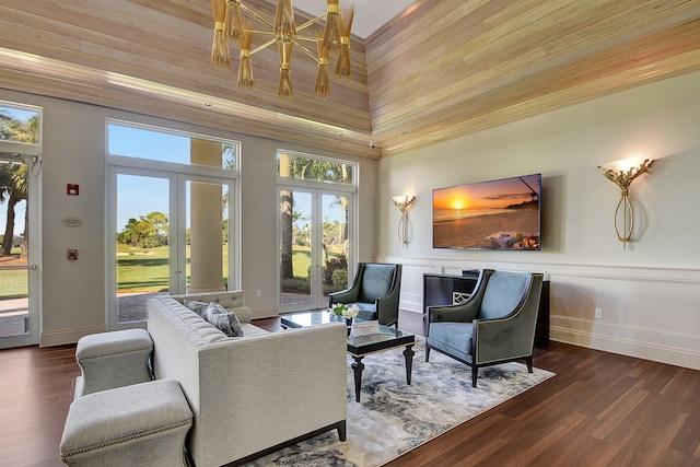 living room featuring french doors, dark hardwood / wood-style flooring, wood ceiling, and a high ceiling