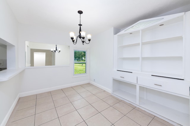 unfurnished dining area featuring light tile patterned flooring and a chandelier