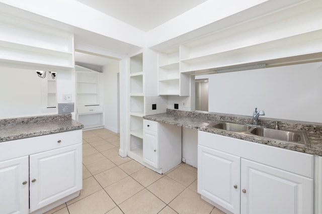 kitchen featuring white cabinetry, sink, and light tile patterned floors