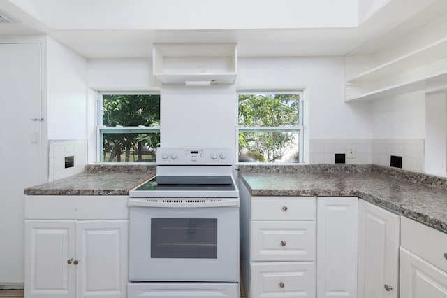 kitchen featuring white cabinets, decorative backsplash, and white electric stove