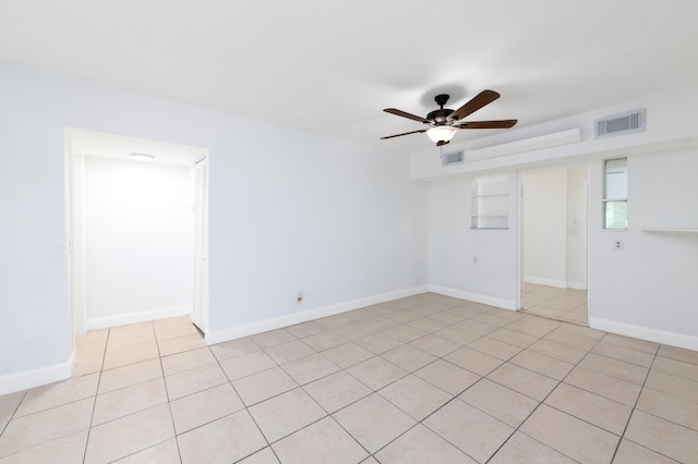 spare room with light tile patterned floors and ceiling fan