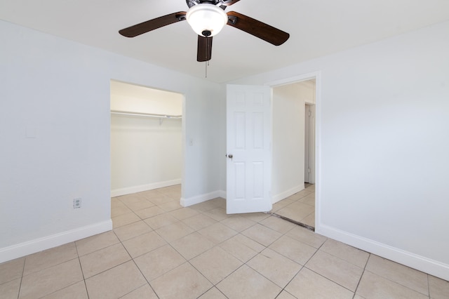 unfurnished bedroom featuring light tile patterned floors, a closet, and ceiling fan