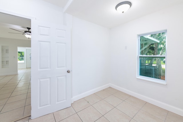 unfurnished room with ceiling fan and light tile patterned floors