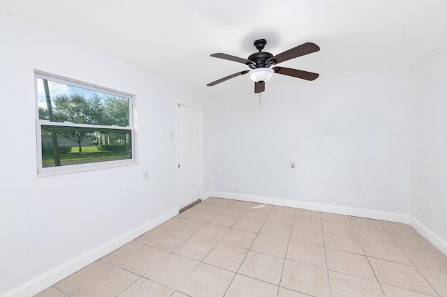 tiled empty room featuring ceiling fan