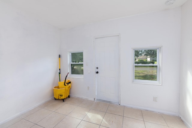 unfurnished room featuring light tile patterned flooring