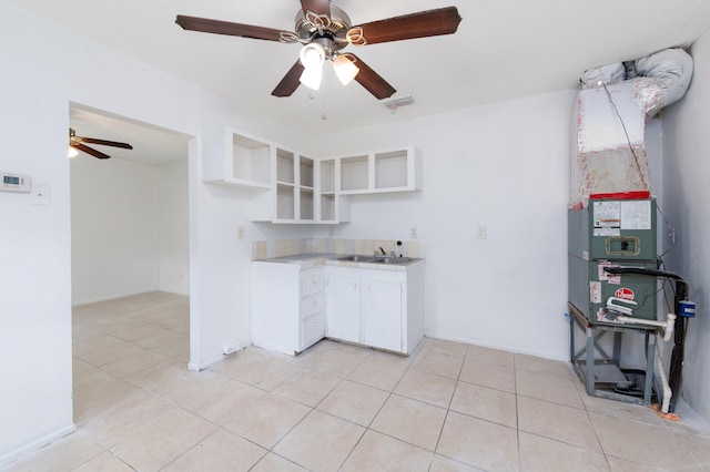 kitchen with ceiling fan, white cabinets, and light tile patterned floors