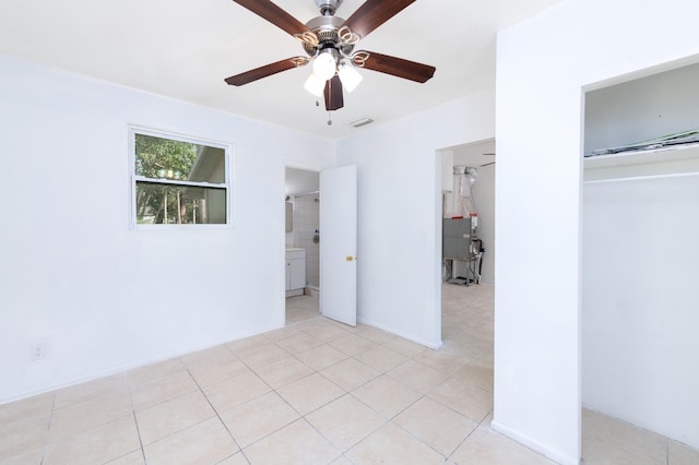 tiled empty room featuring ceiling fan