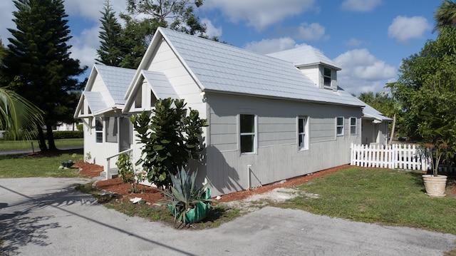 view of property exterior with a yard