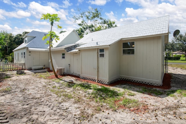 rear view of house featuring cooling unit