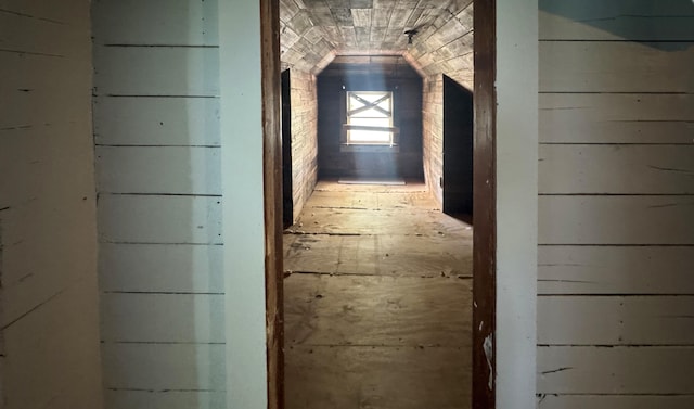 hallway with lofted ceiling