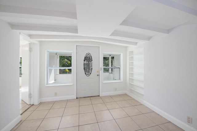 foyer entrance featuring beam ceiling and light tile patterned floors