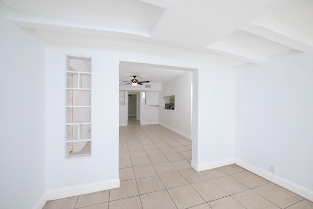 tiled spare room with ceiling fan