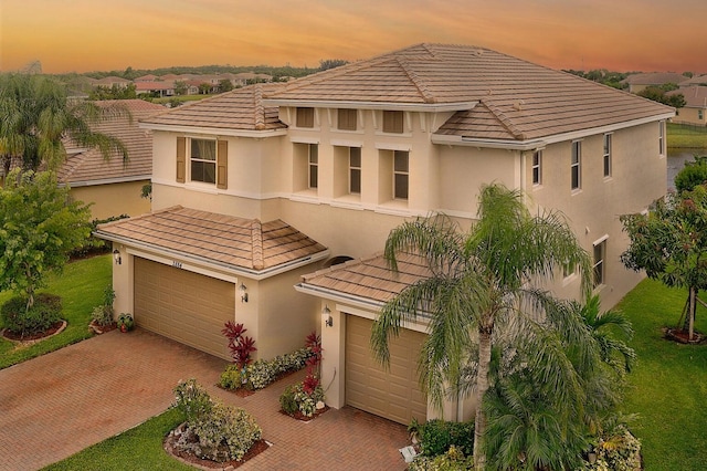 mediterranean / spanish-style house with a garage