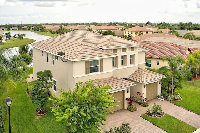 view of front of home with a water view and a front lawn