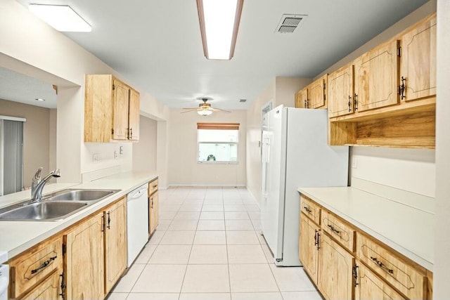 kitchen featuring light brown cabinets, white appliances, light tile patterned floors, and sink